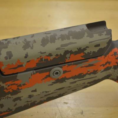 Bolt shroud inlet in cheek piece to allow full bolt functionality